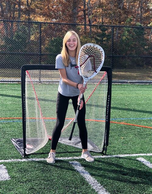student playing lacrosse goalie 